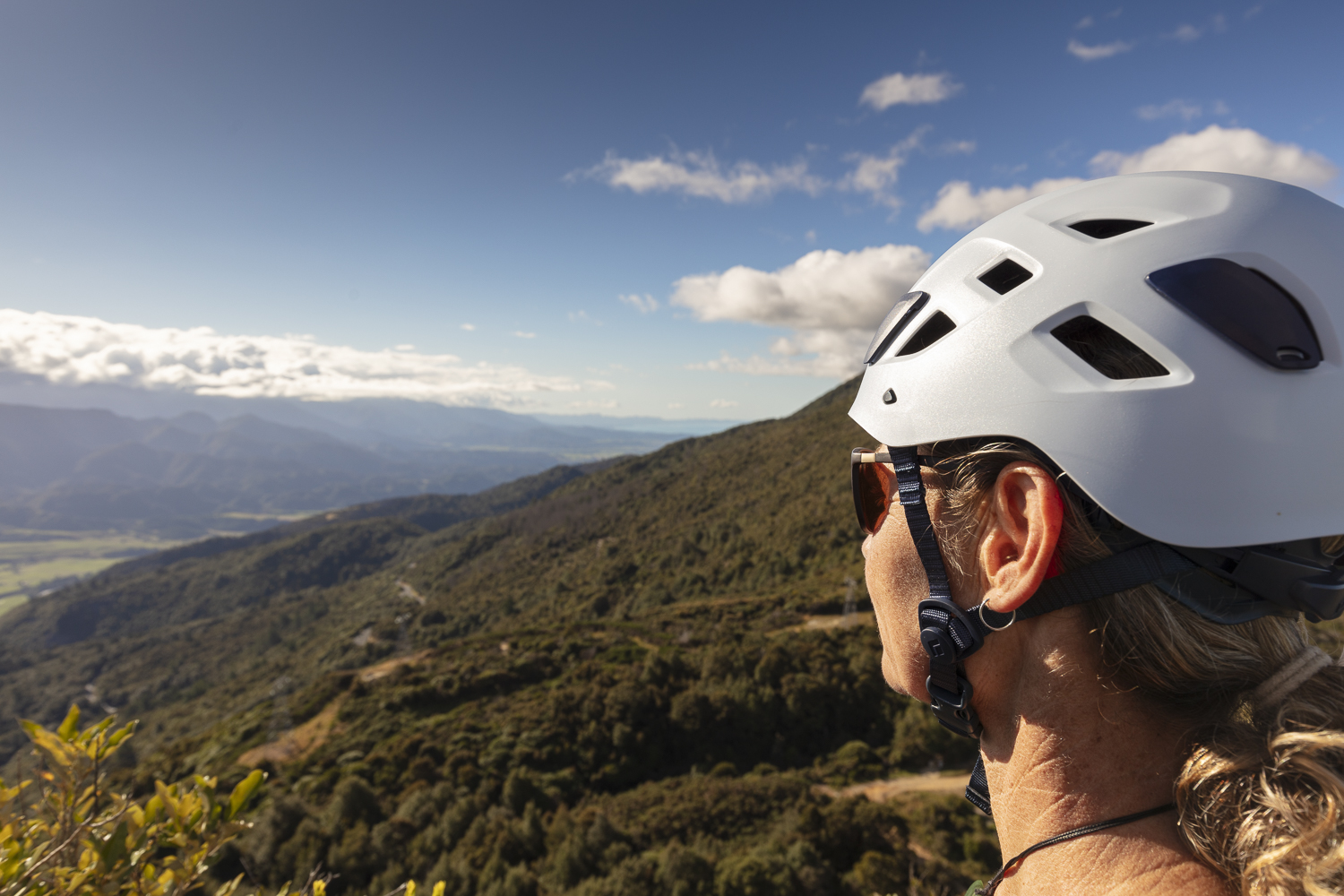 Adventurers clipped into the via ferrata route traversing steep limestone cliffs.